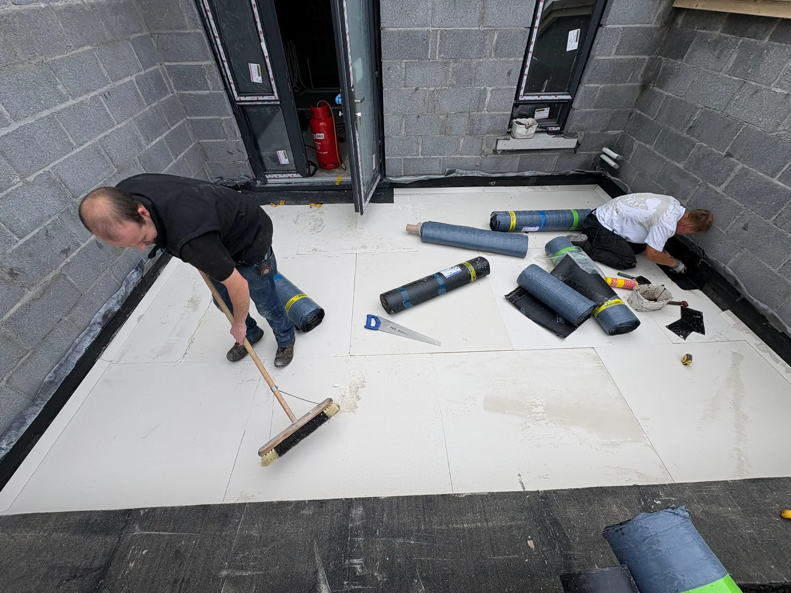 Roofing team working on a flat roof in Mayo